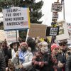 Protesters wave signs at anti-Trump rally, Denver, 4/5/25. Photo: Beth Schneider