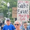 Protester in Greeley Saturday carrying a sign that says Gabe Evans Must Go!