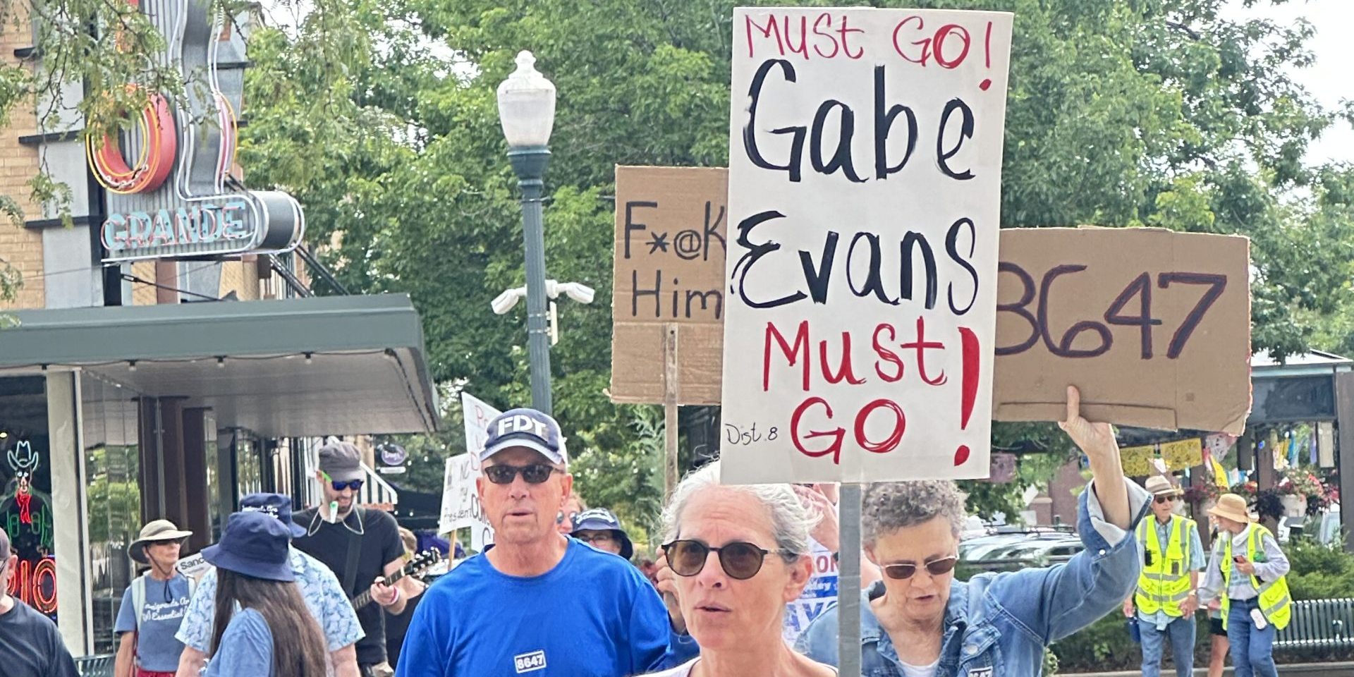 Protester in Greeley Saturday carrying a sign that says Gabe Evans Must Go!