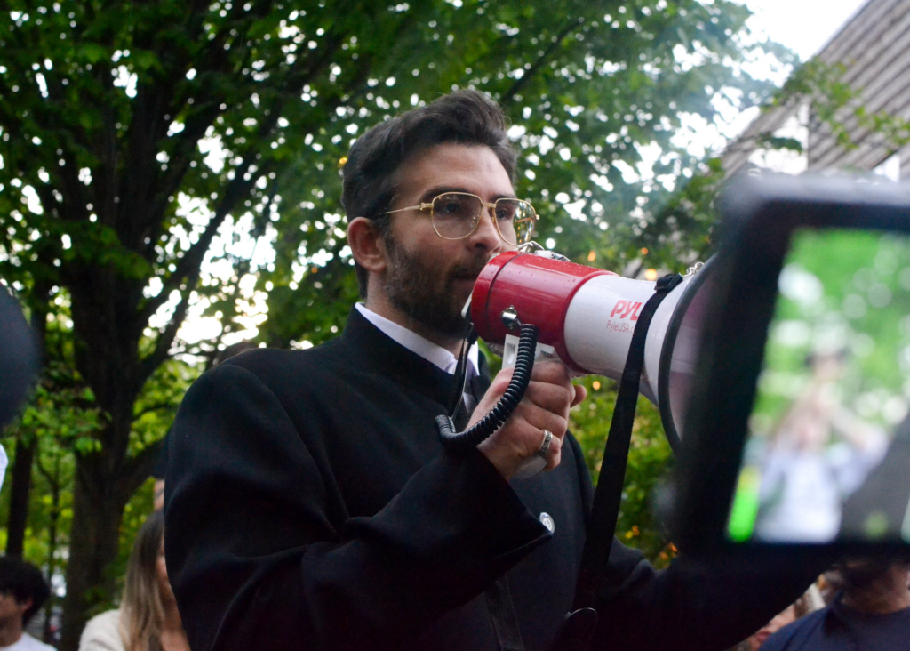 Piker speaking at rally.
