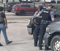 ICE agents surrounding a truck driver at a gas station in Colorado Springs. Photo: CORNN